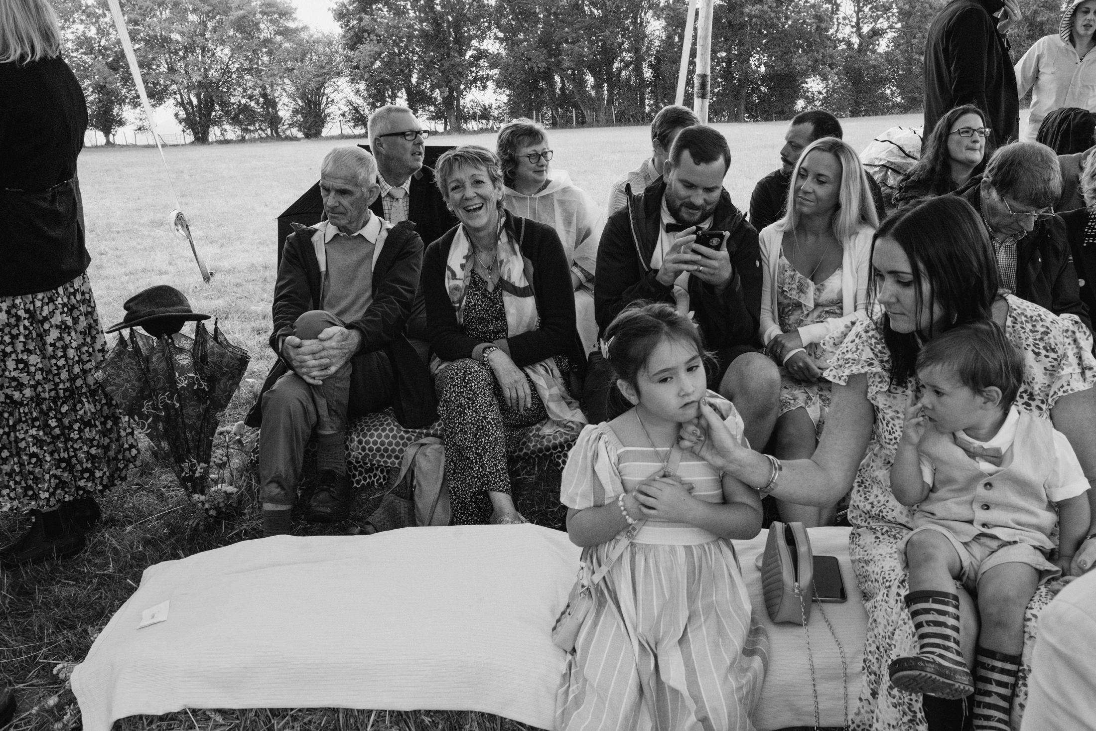 People sitting outdoors at a casual gathering.