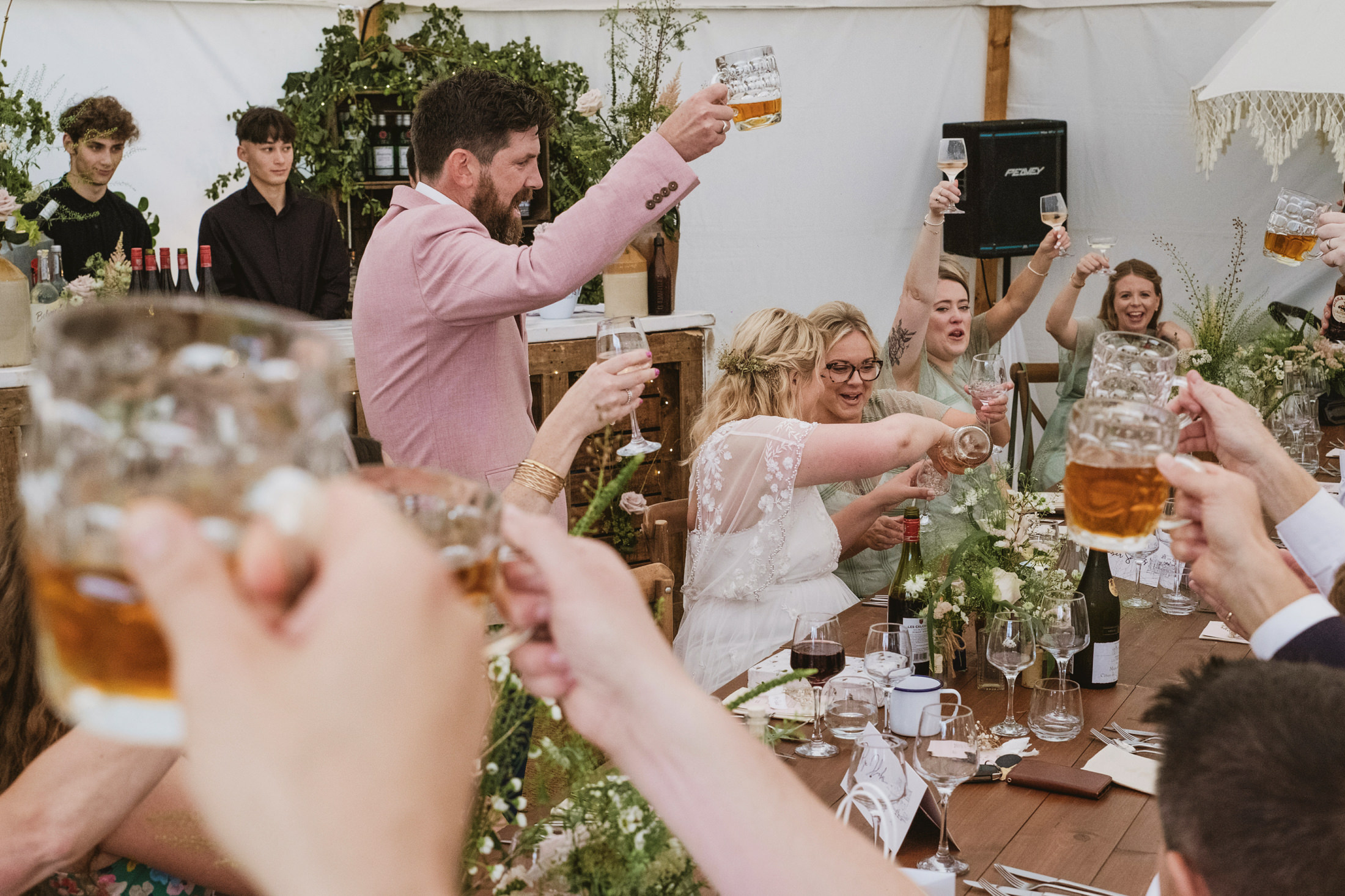 Wedding guests raising glasses in celebration