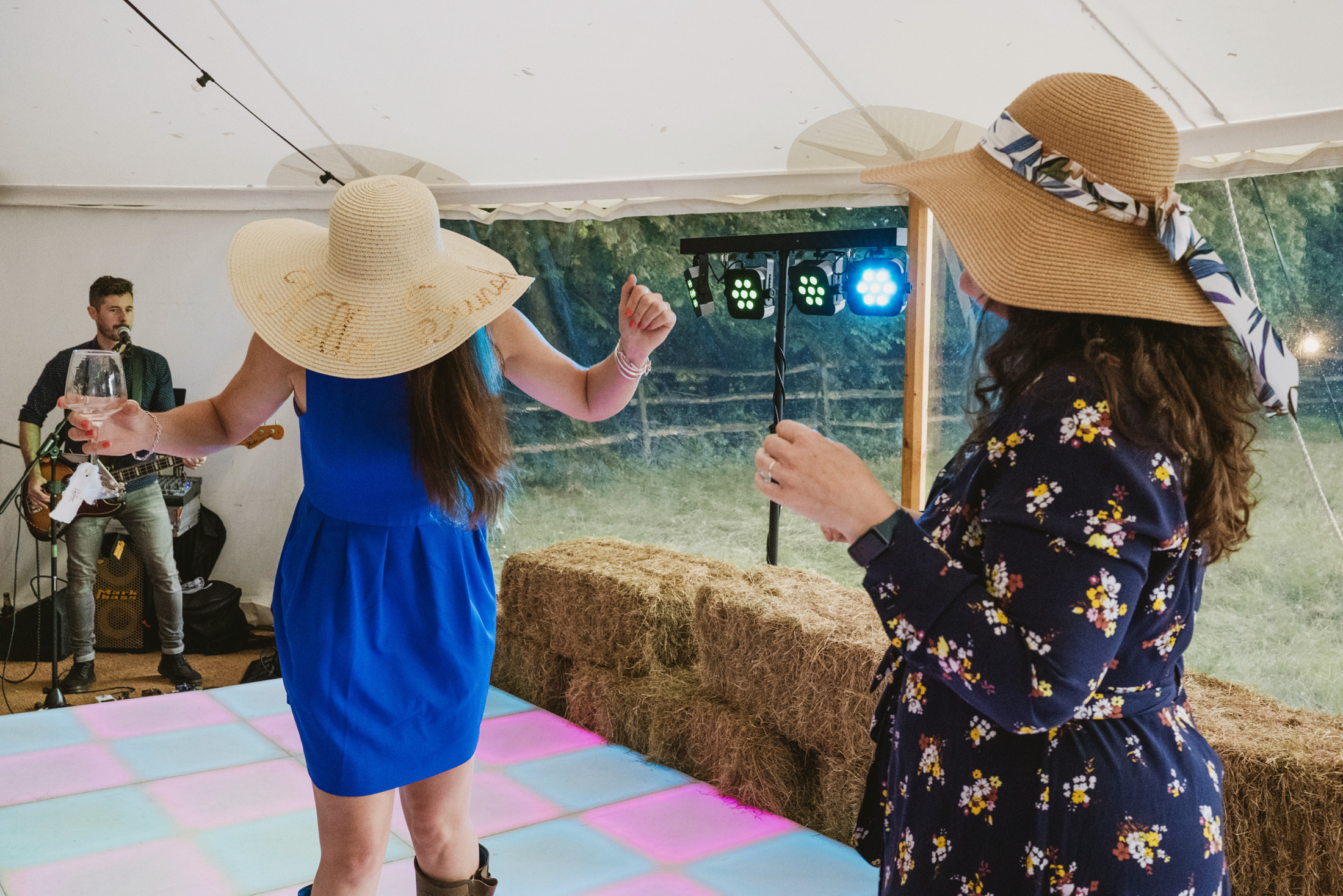 Women dancing at outdoor party with live music.