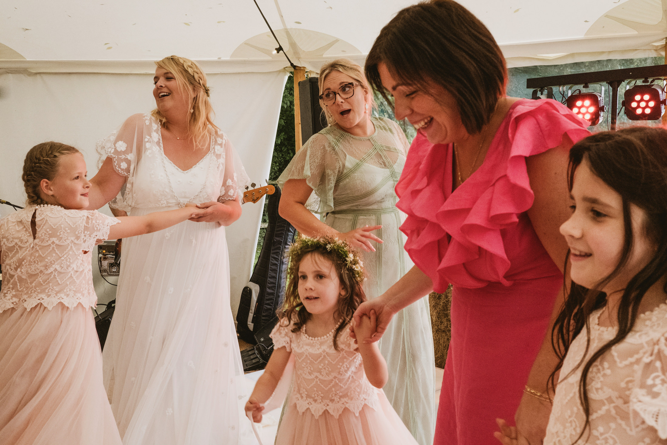 Women and children dancing at a wedding celebration.