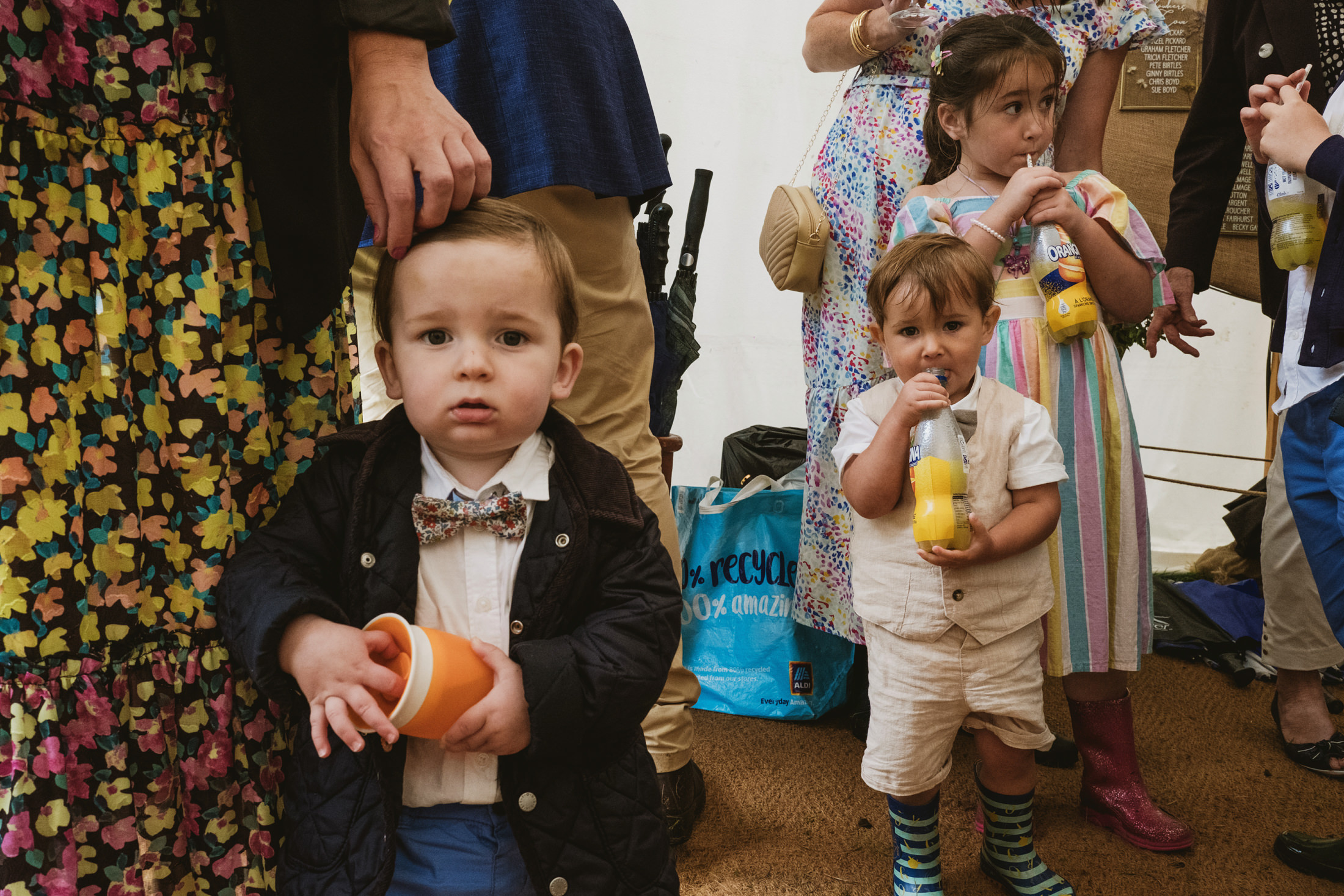 Children drinking juice, colourful clothing, party atmosphere.