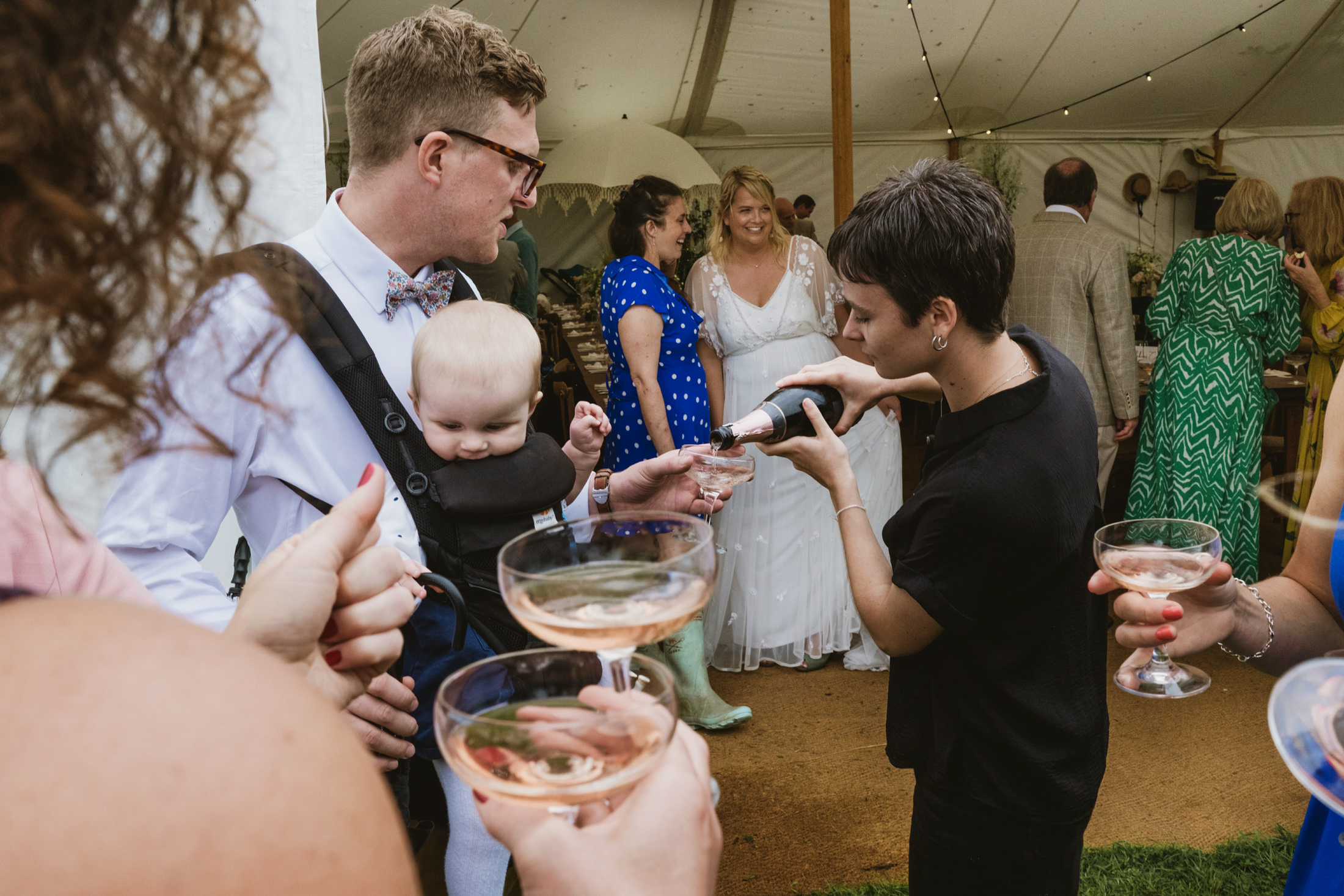 Waiter pouring champagne at a wedding reception.