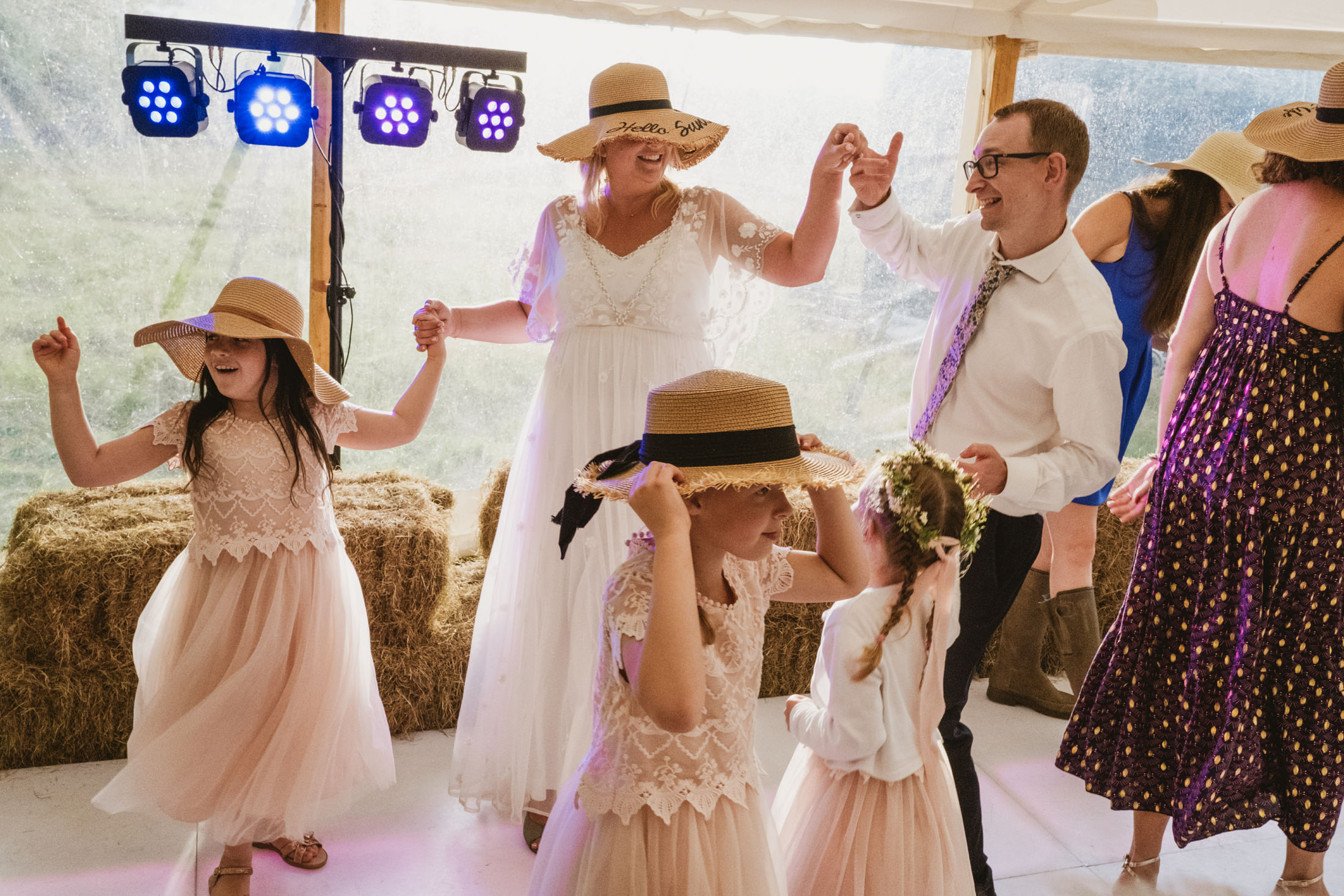 People dancing at a rustic wedding celebration.