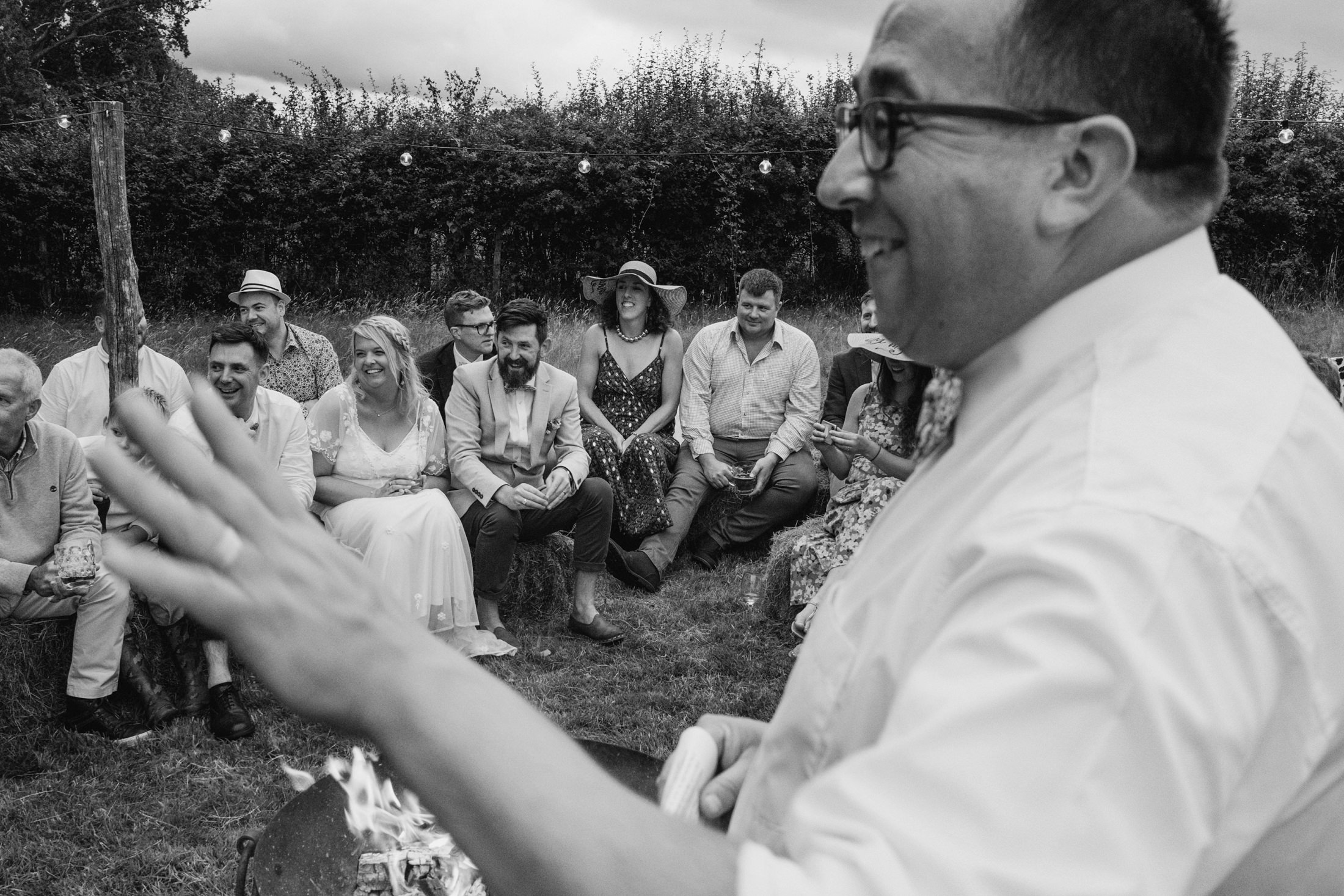 Outdoor gathering with people seated, smiling.