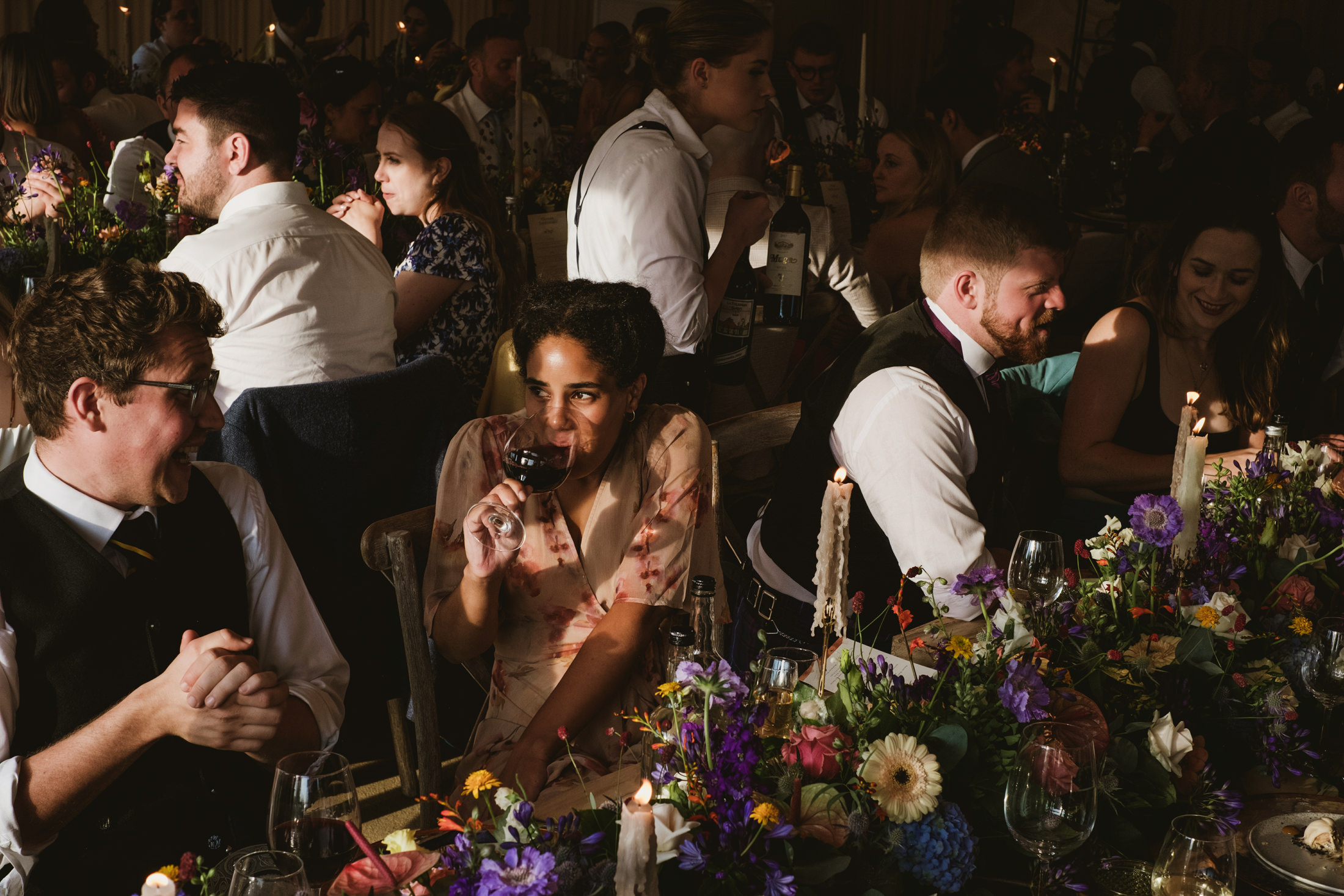 Guests enjoying wine at a festive dinner party.