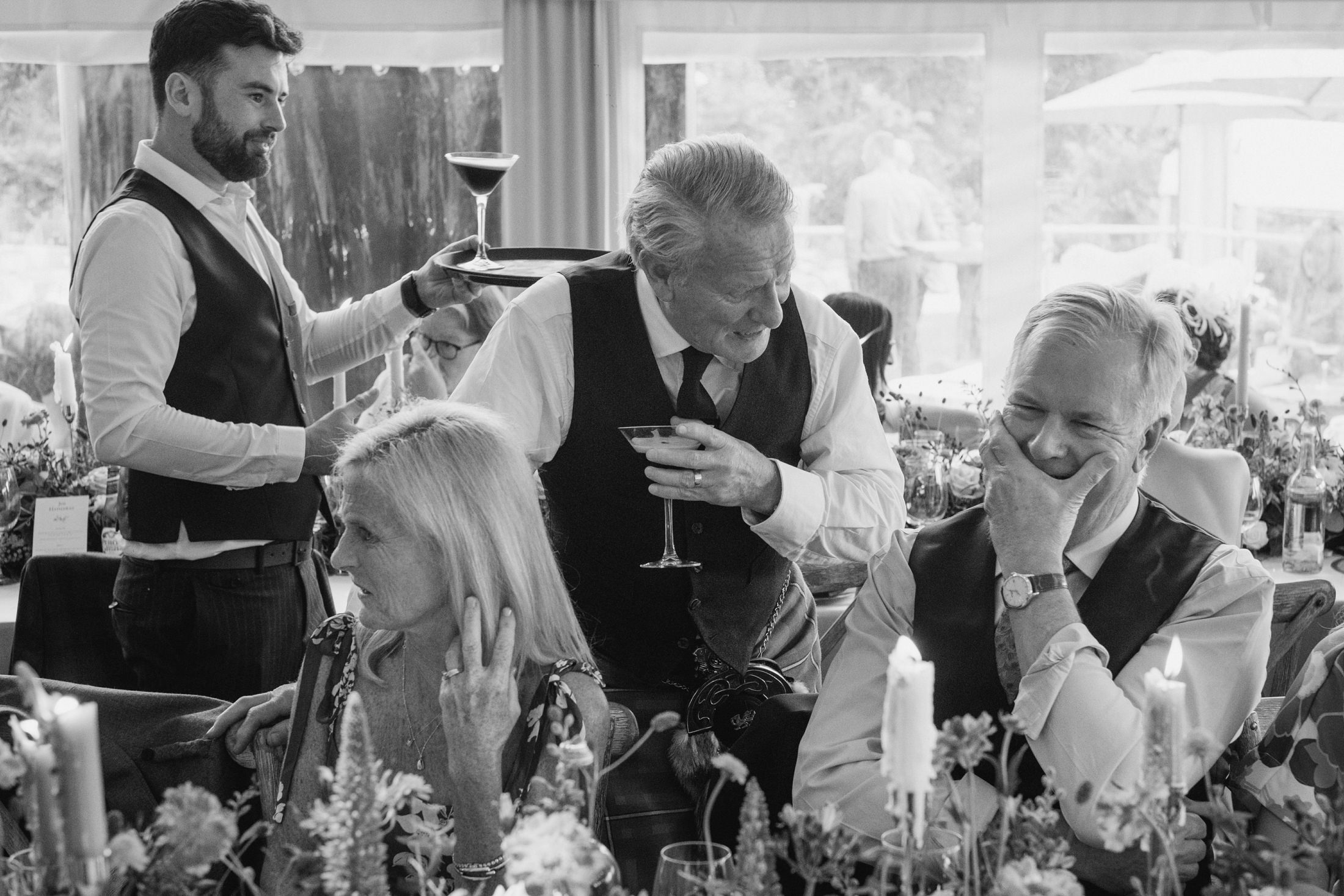 Group of people laughing at a party table