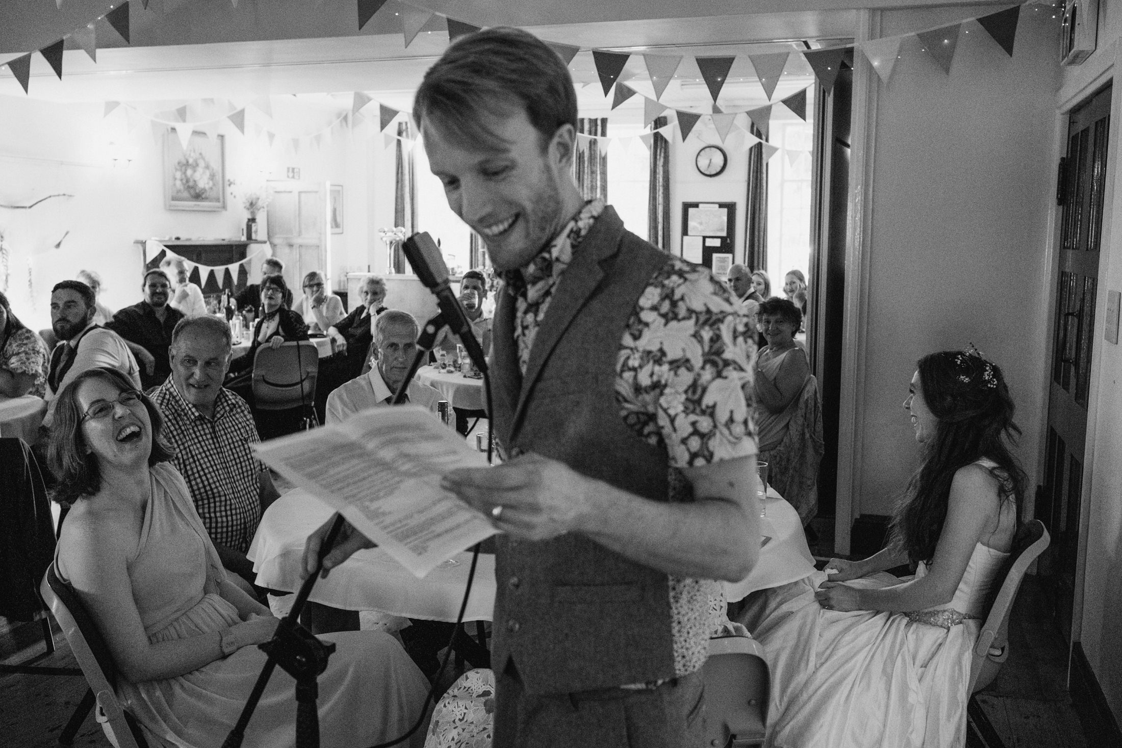 Man giving a speech at a wedding reception.