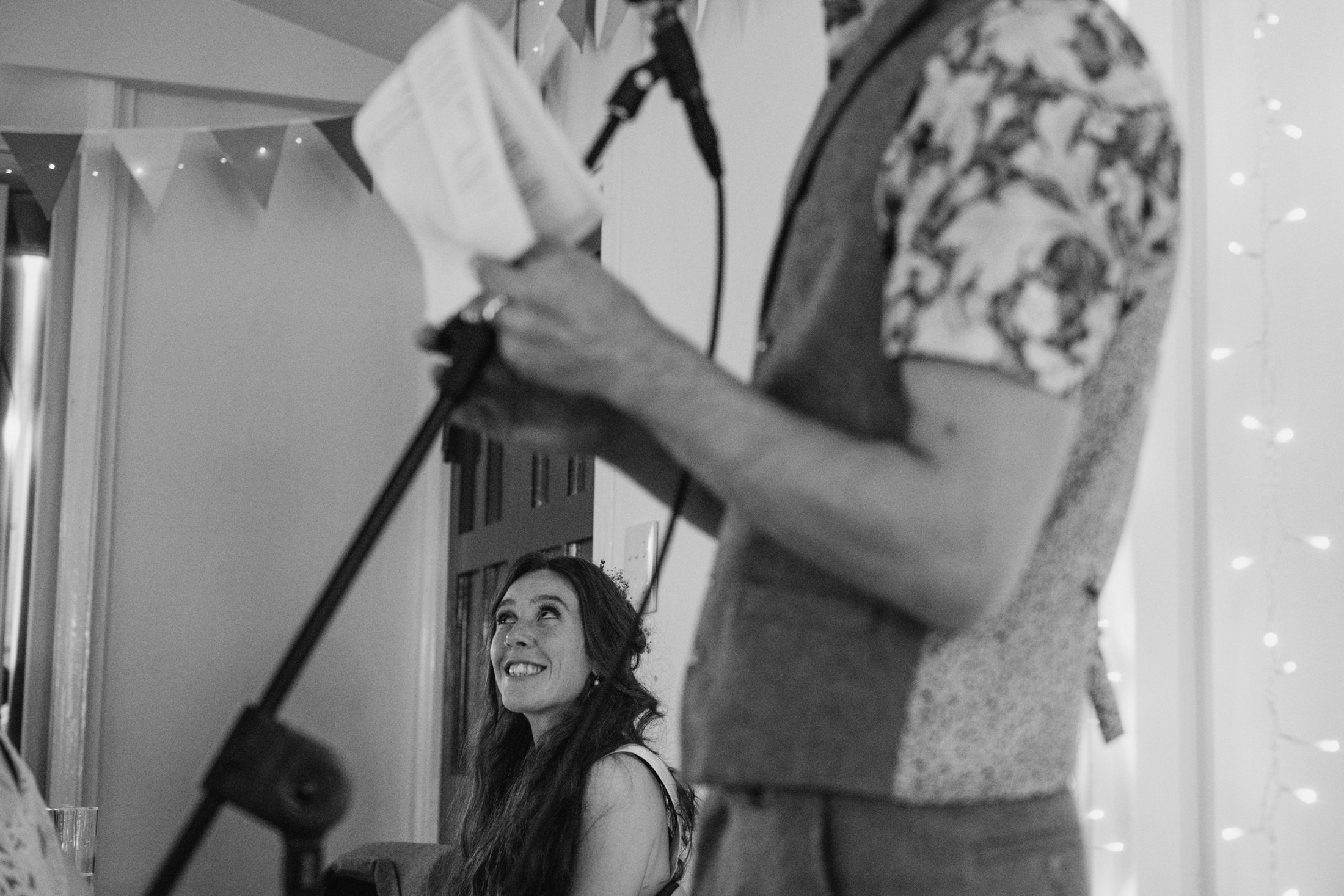 Woman smiling during speech at event.