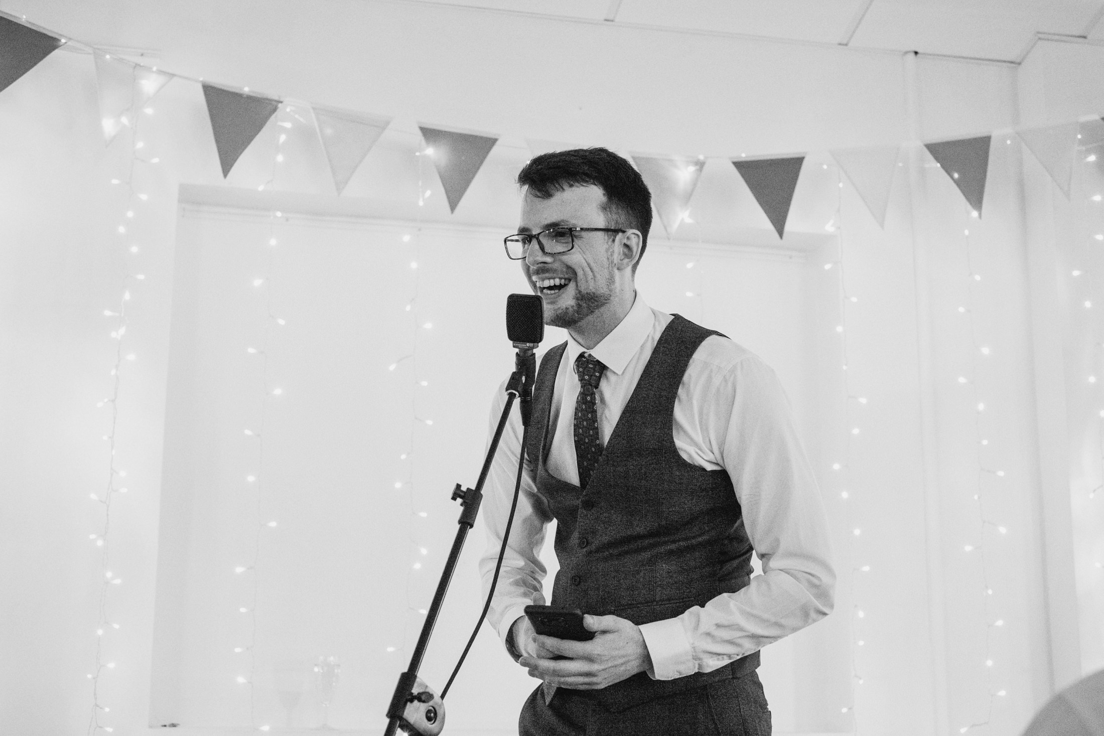 Man speaking into microphone at event.