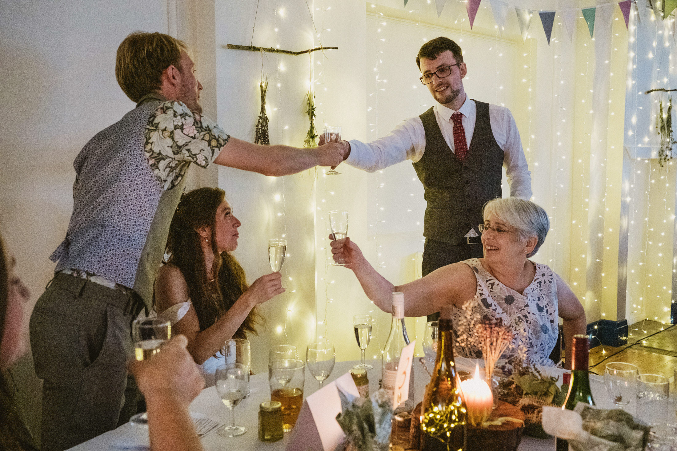 Group toasting at a festive dinner party.