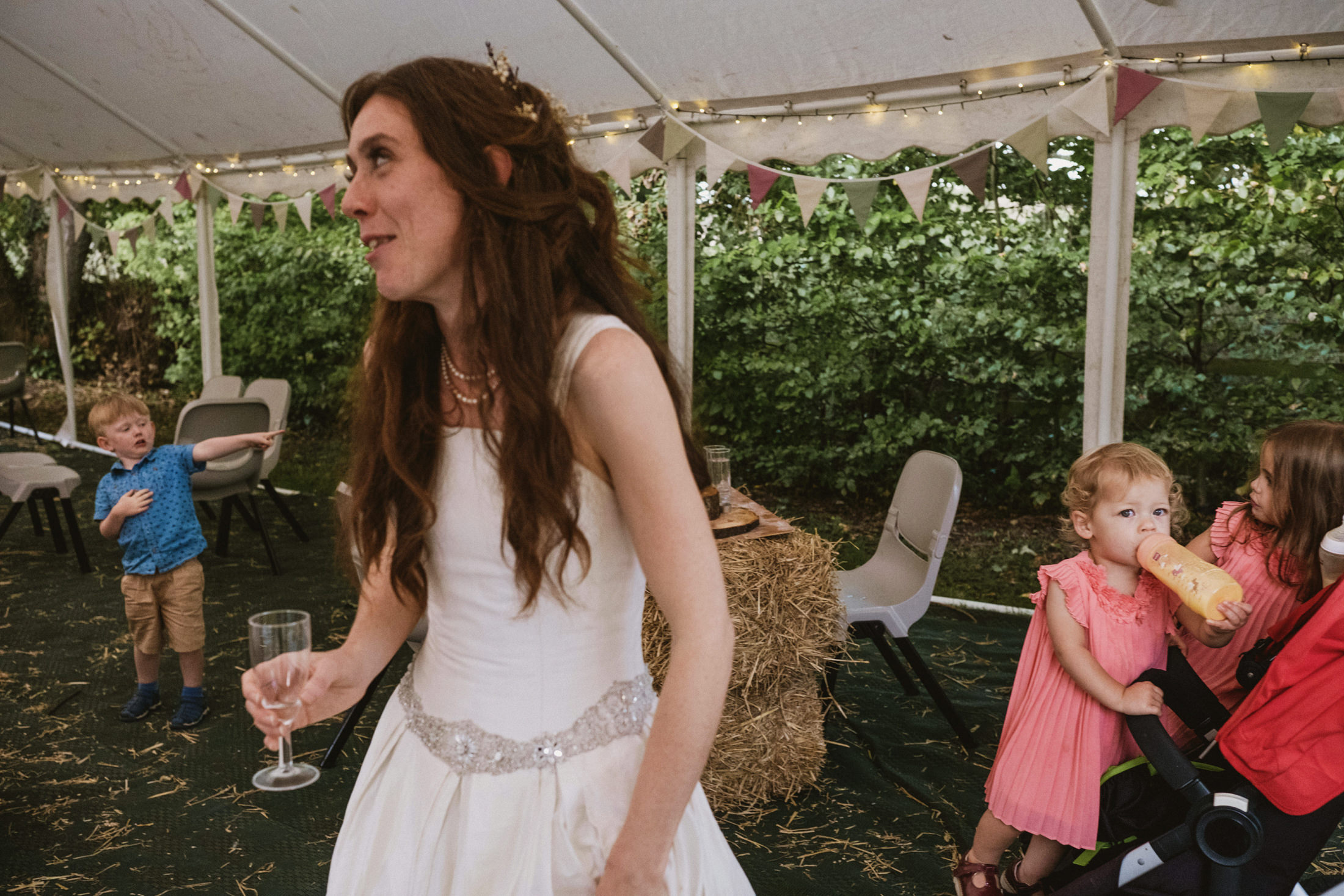 Woman in bridal dress with children at a wedding