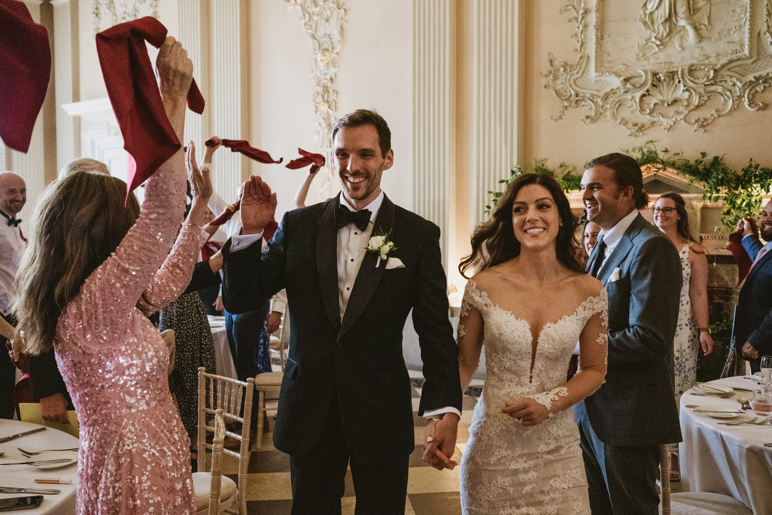Bride and groom greeted at wedding reception. Ragley Hall wedding photography; using grand Palladian architecture as a backdrop for documentary storytelling