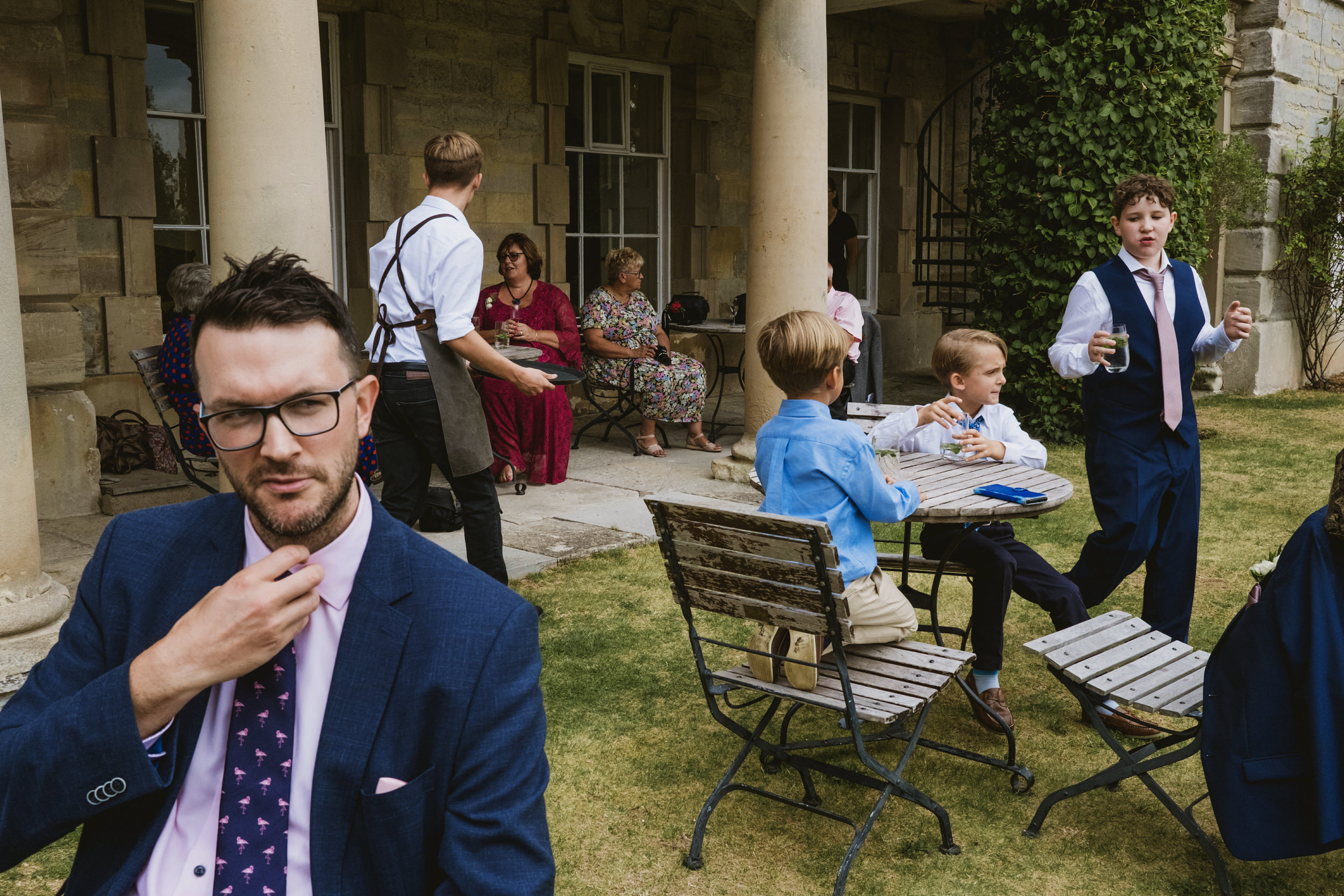 Group enjoying outdoor gathering at a formal event.