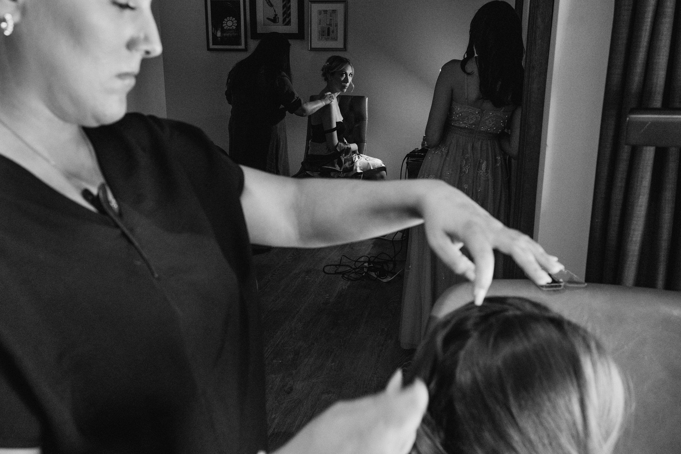 Women preparing for event, hairstyling and dressing.