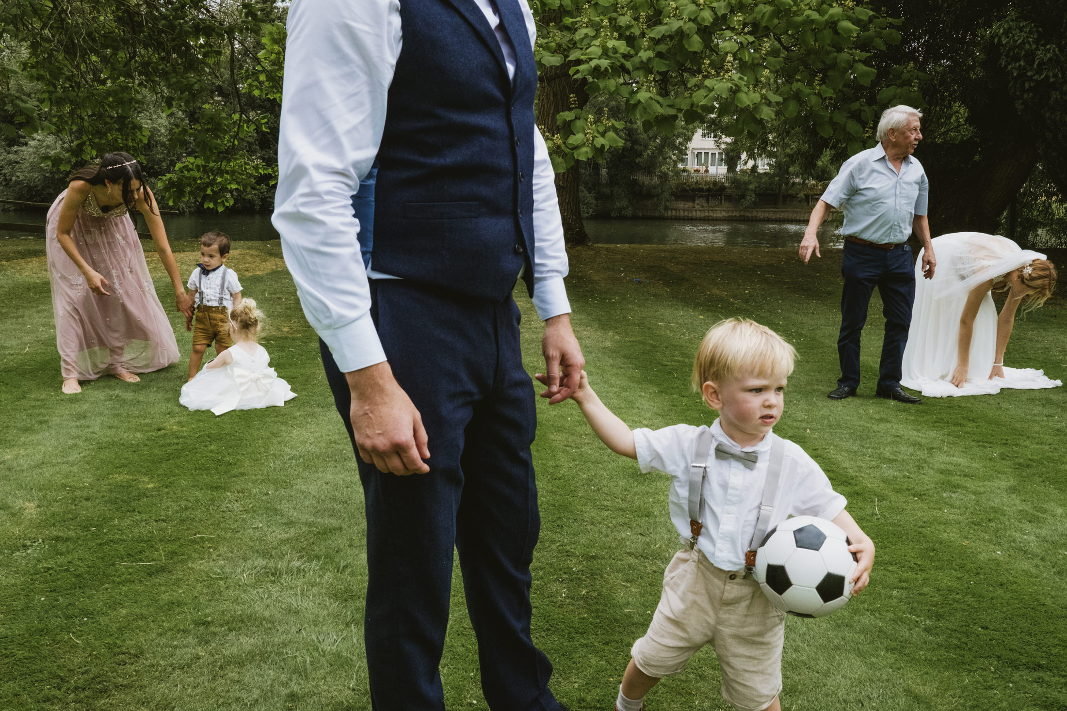 Wedding scene with children and football on grass