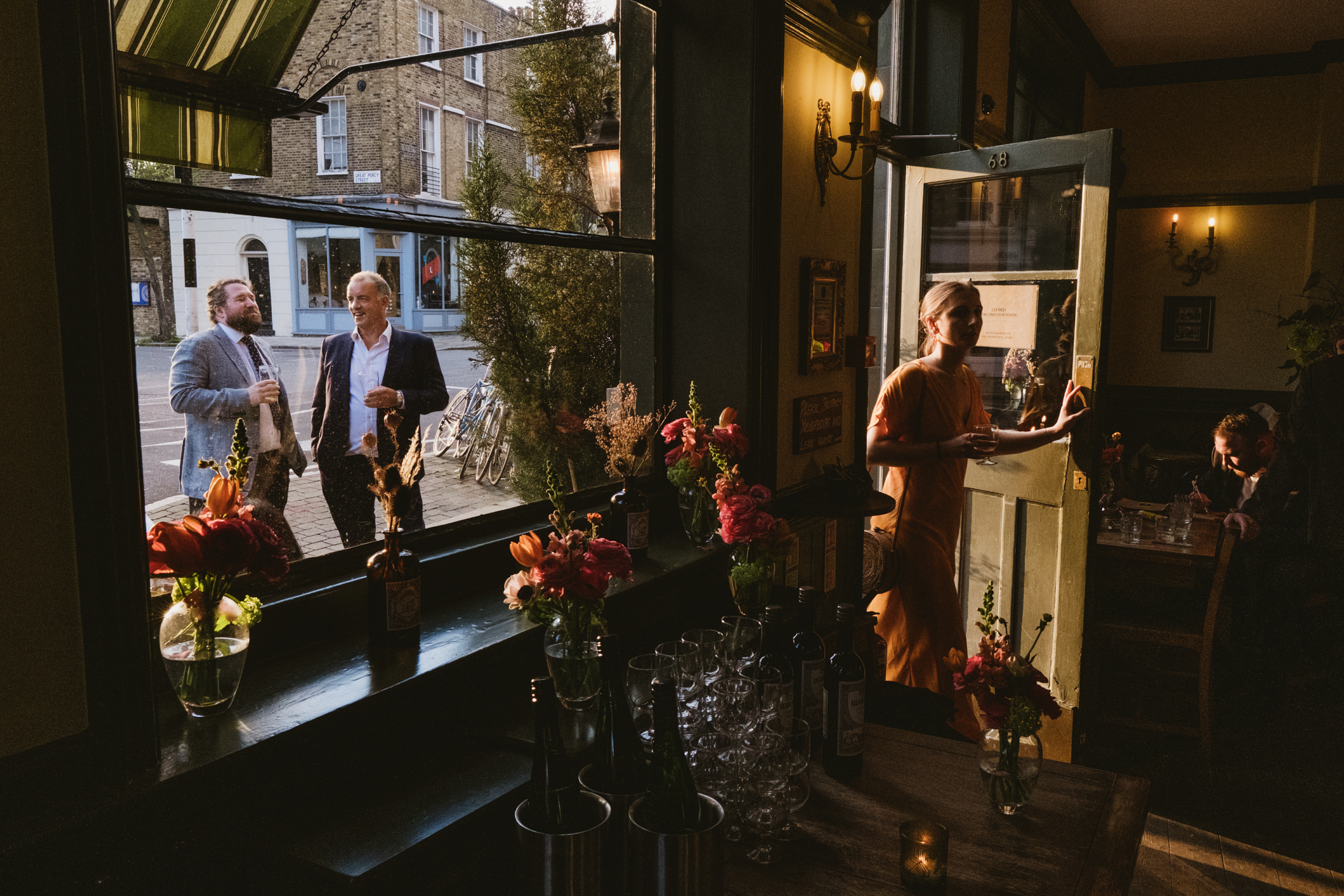 Warm indoor scene with people and flowers.