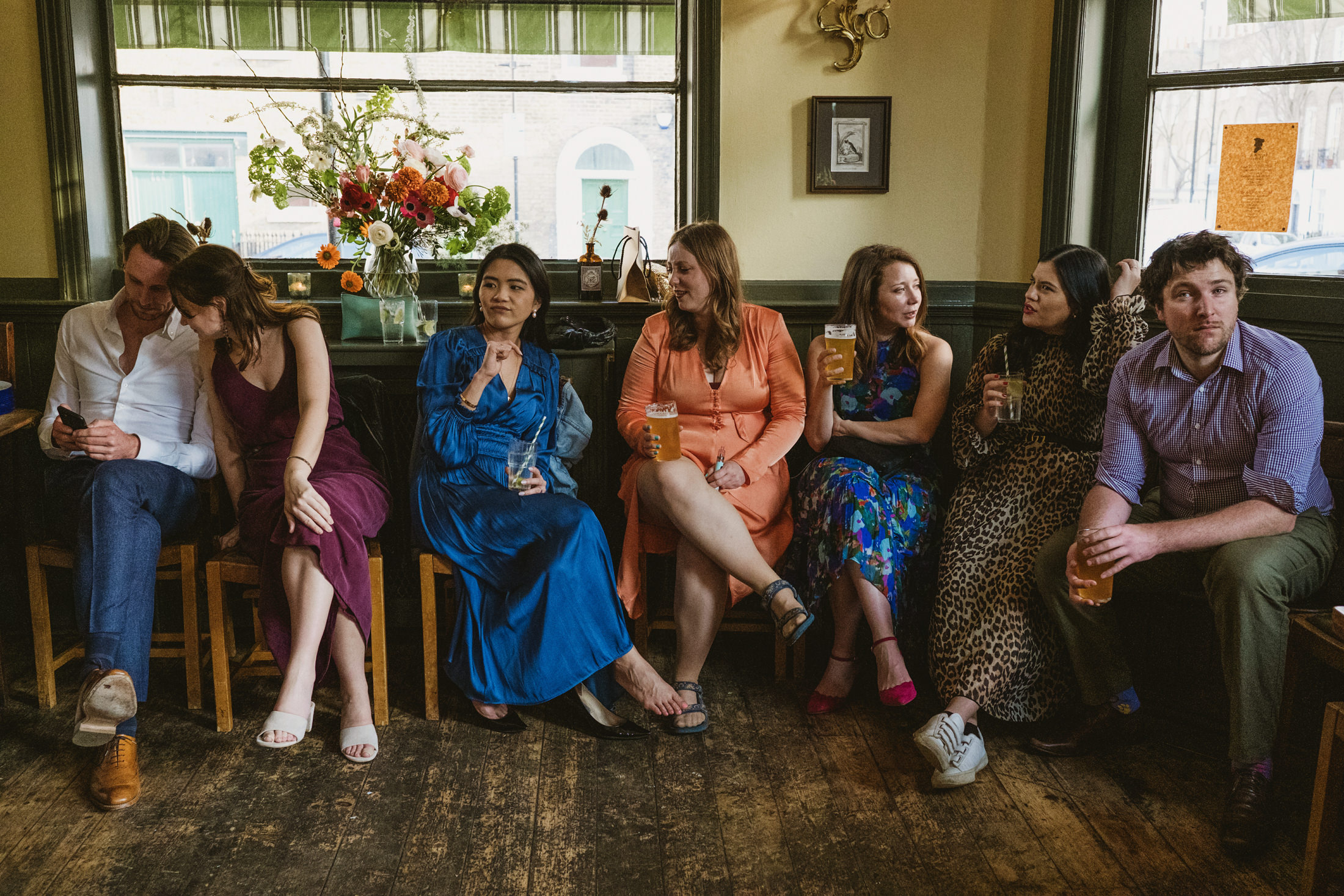 Group of friends enjoying drinks in a pub.
