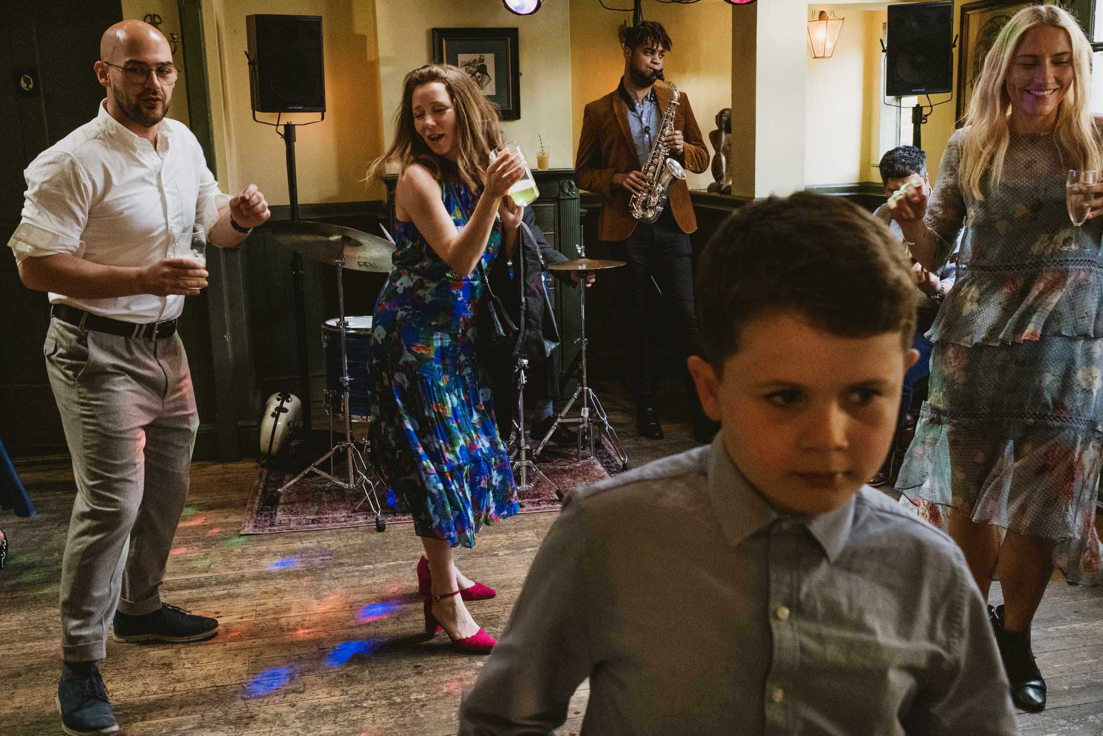People dancing with saxophone player in background