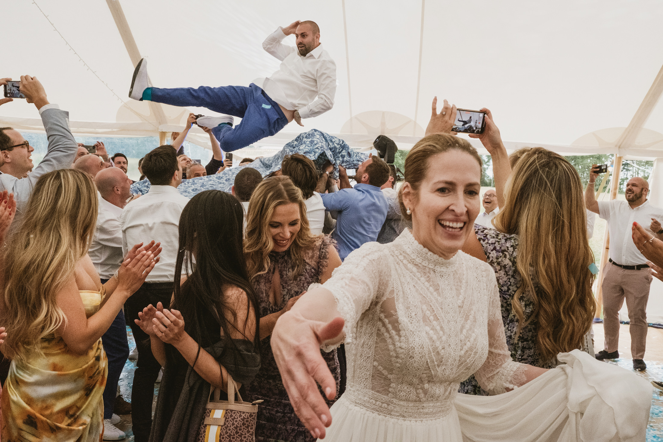 Wedding celebration with dancing and rejoicing guests.