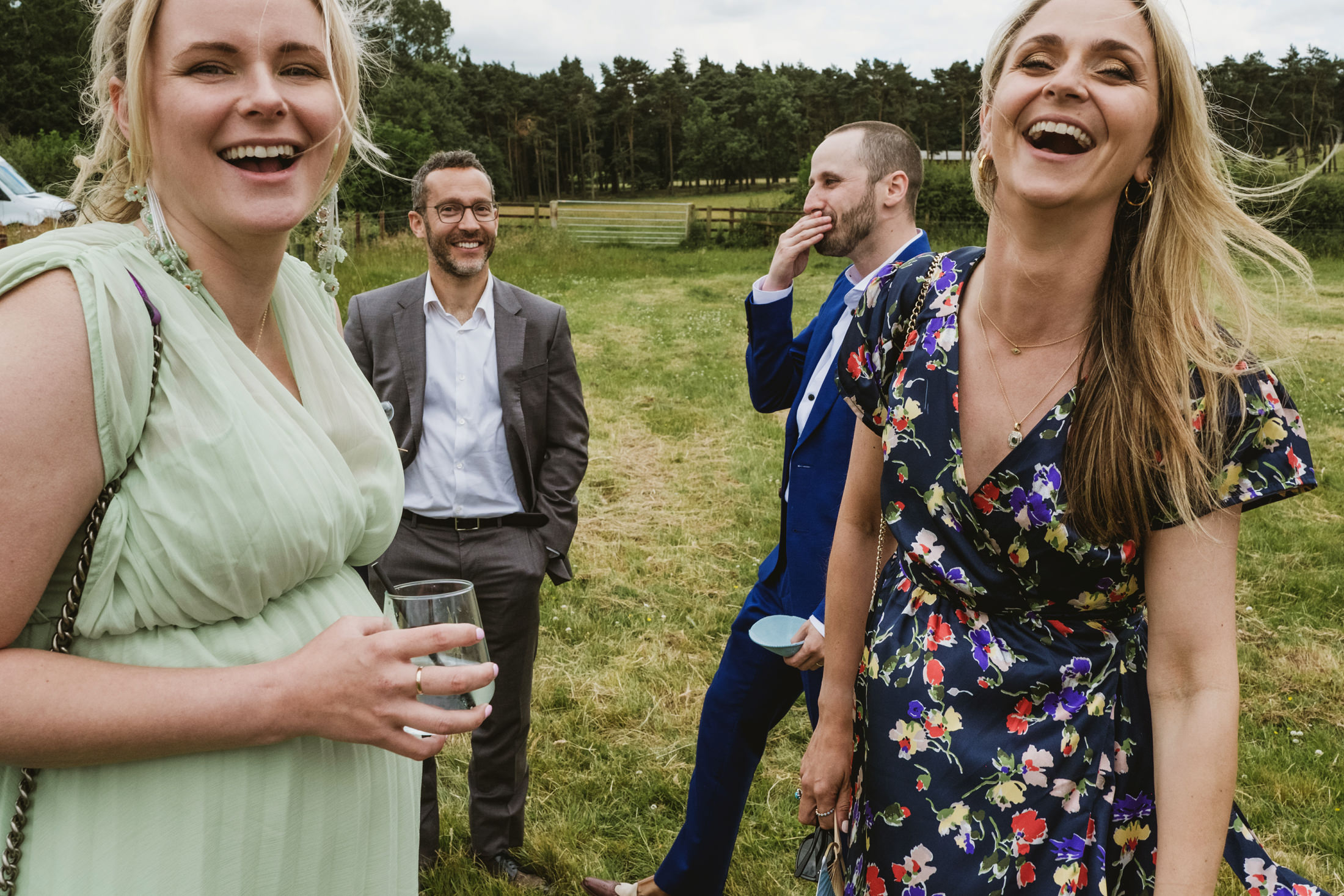 Group laughing outdoors at a gathering