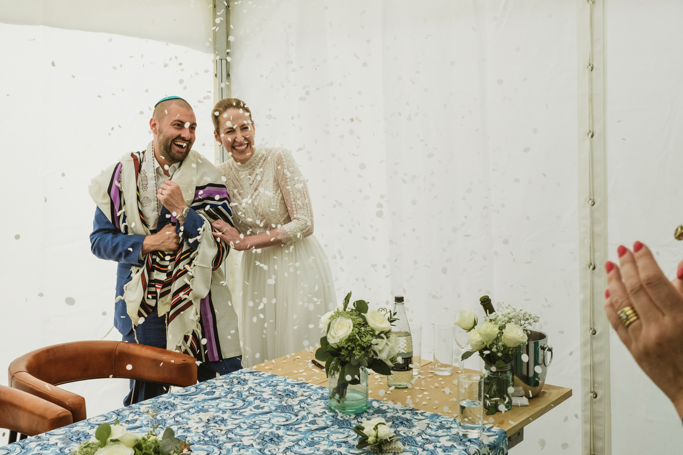 Happy bride and groom in ceremonial attire celebrating.