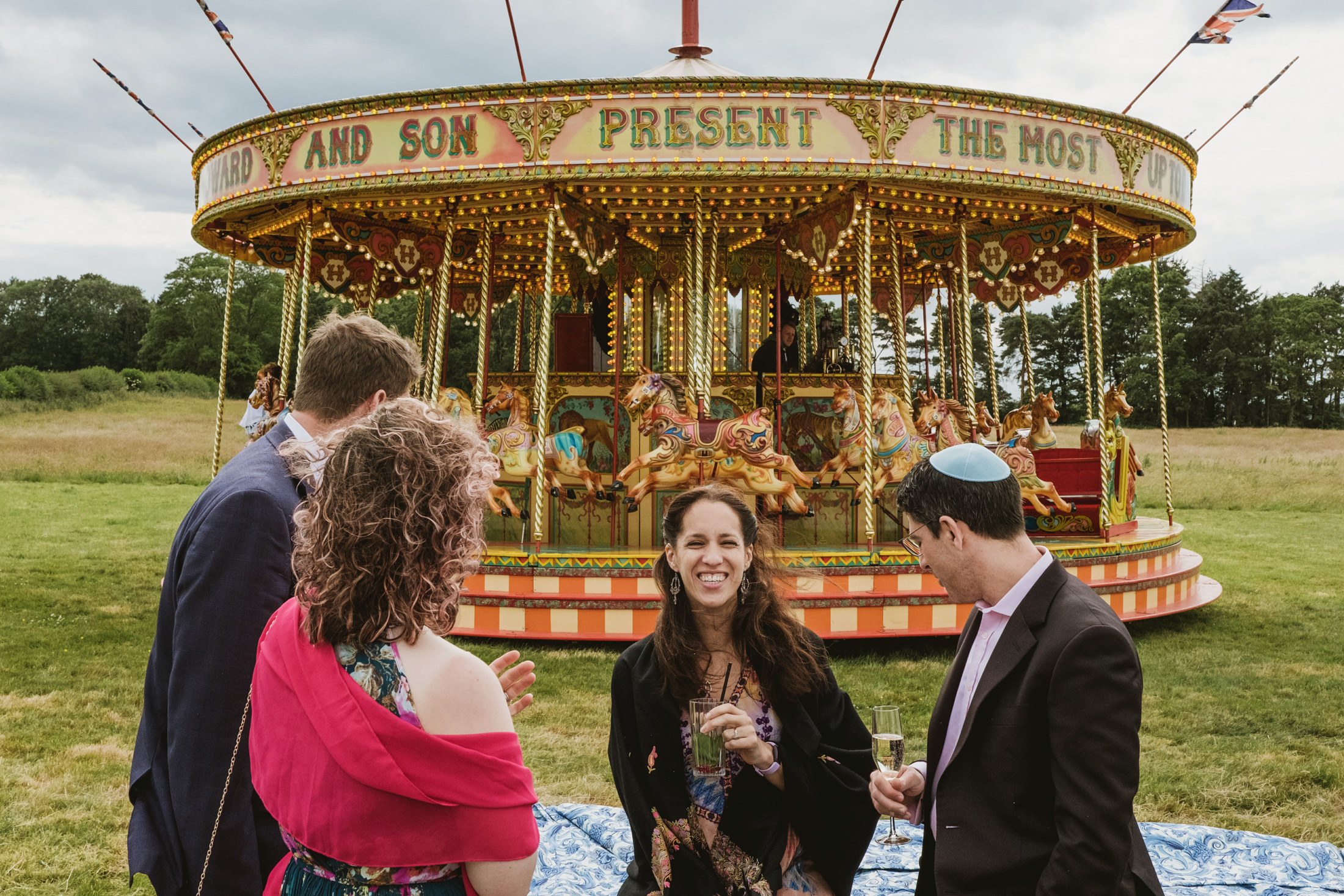 People enjoying carousel at outdoor event.