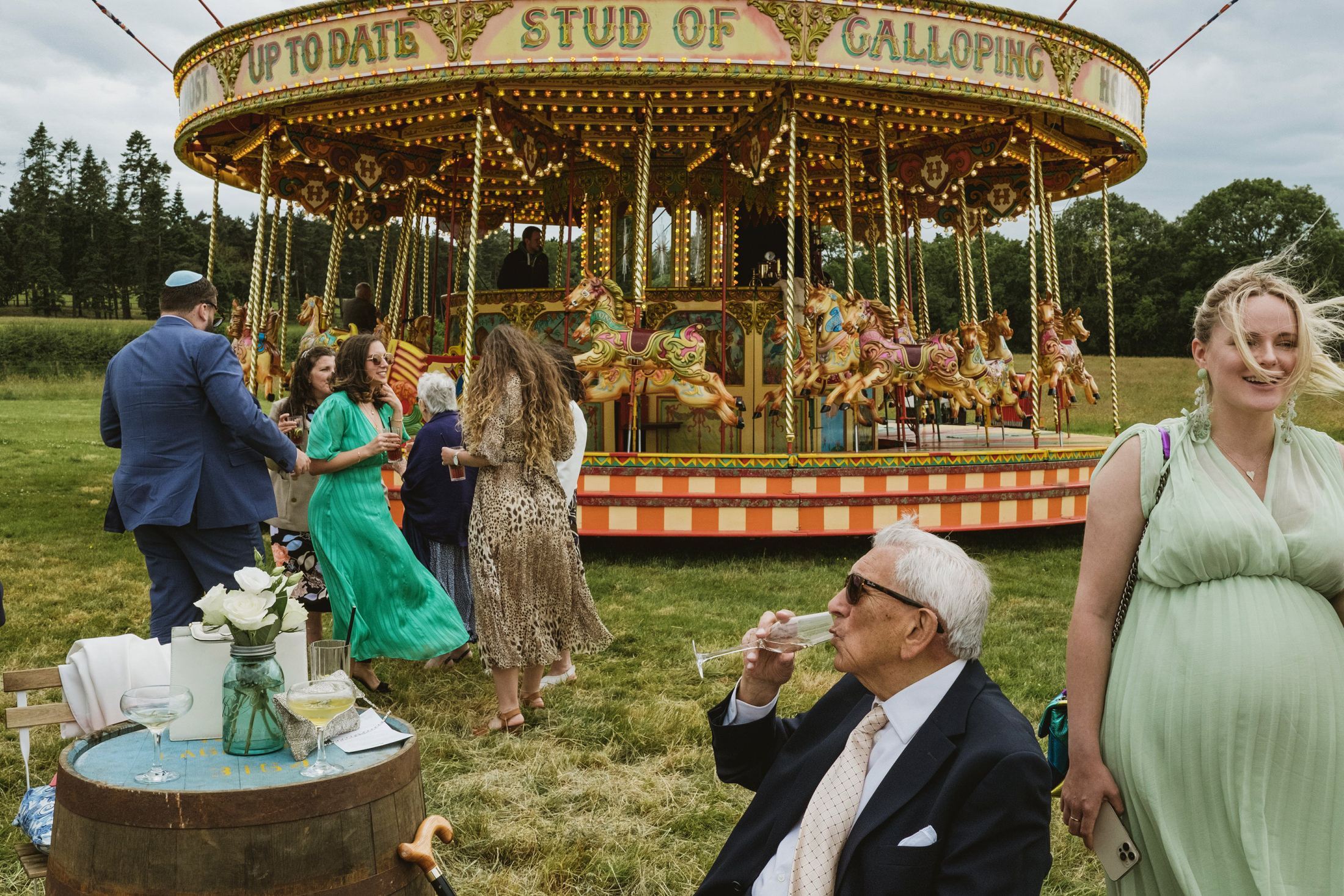 Guests enjoying carousel at outdoor event.