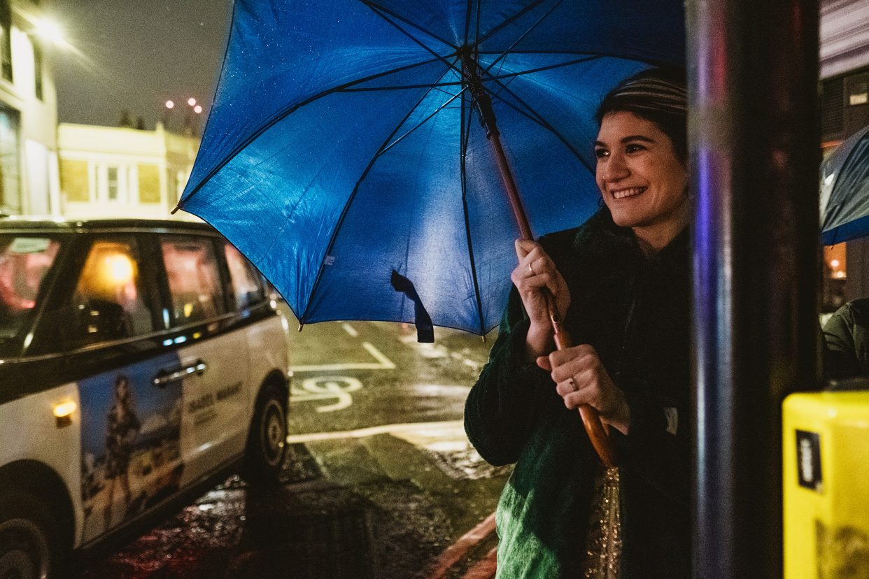The Victorian Bath House Wedding Photography London. Walking to the venue, bride holding blue umbrella.