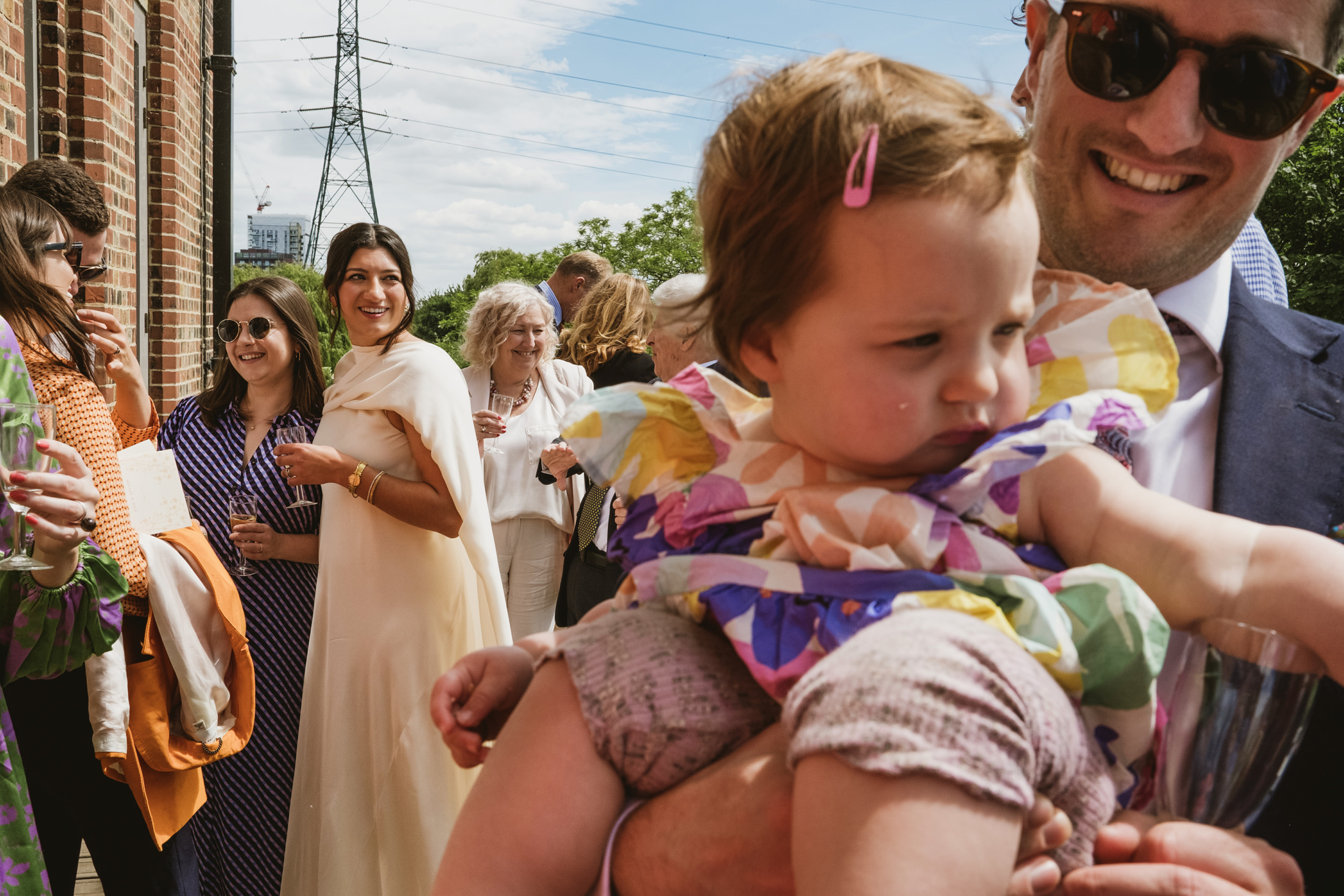 Group of people at outdoor event, sunny day.