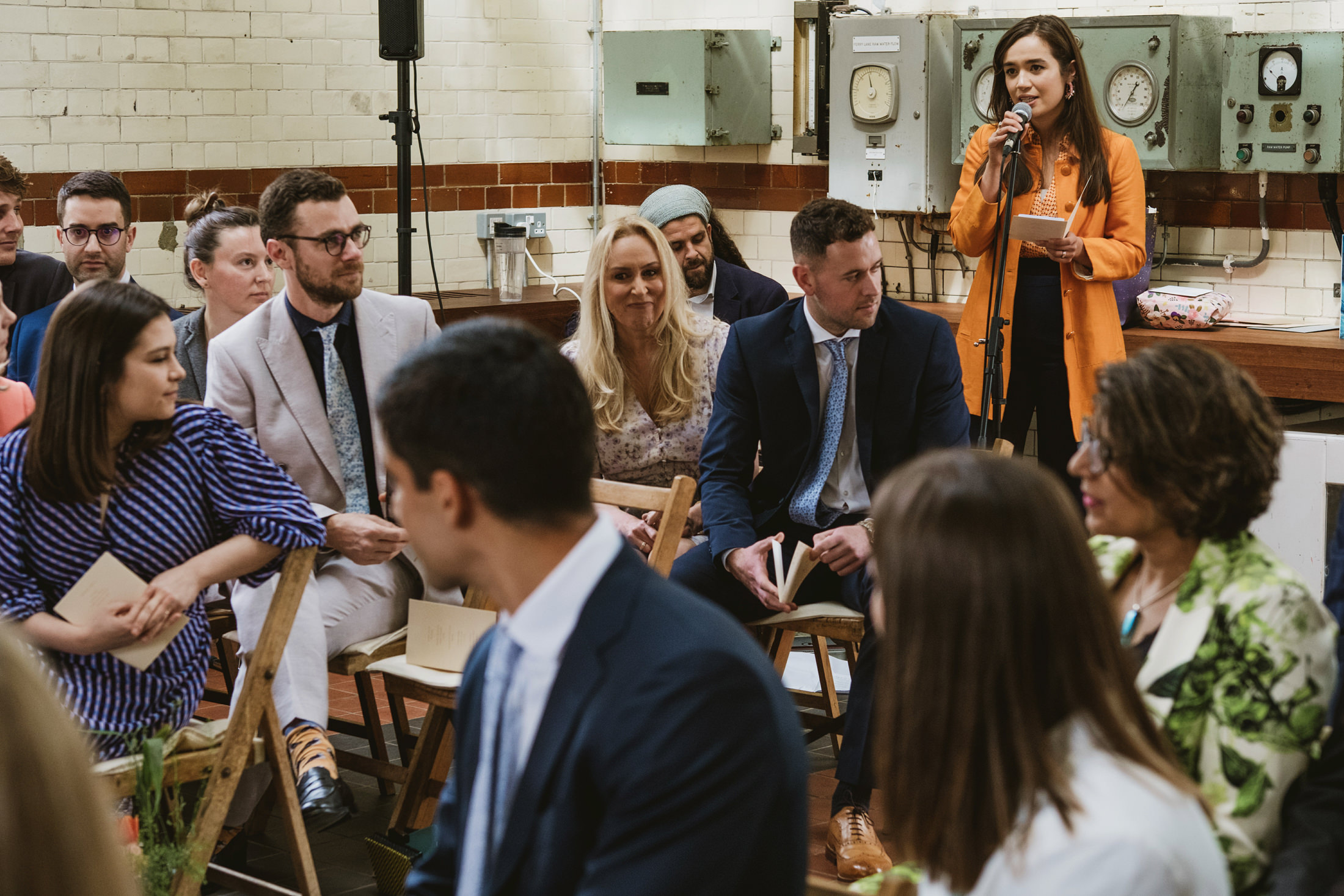 People attending an indoor event with speaker.