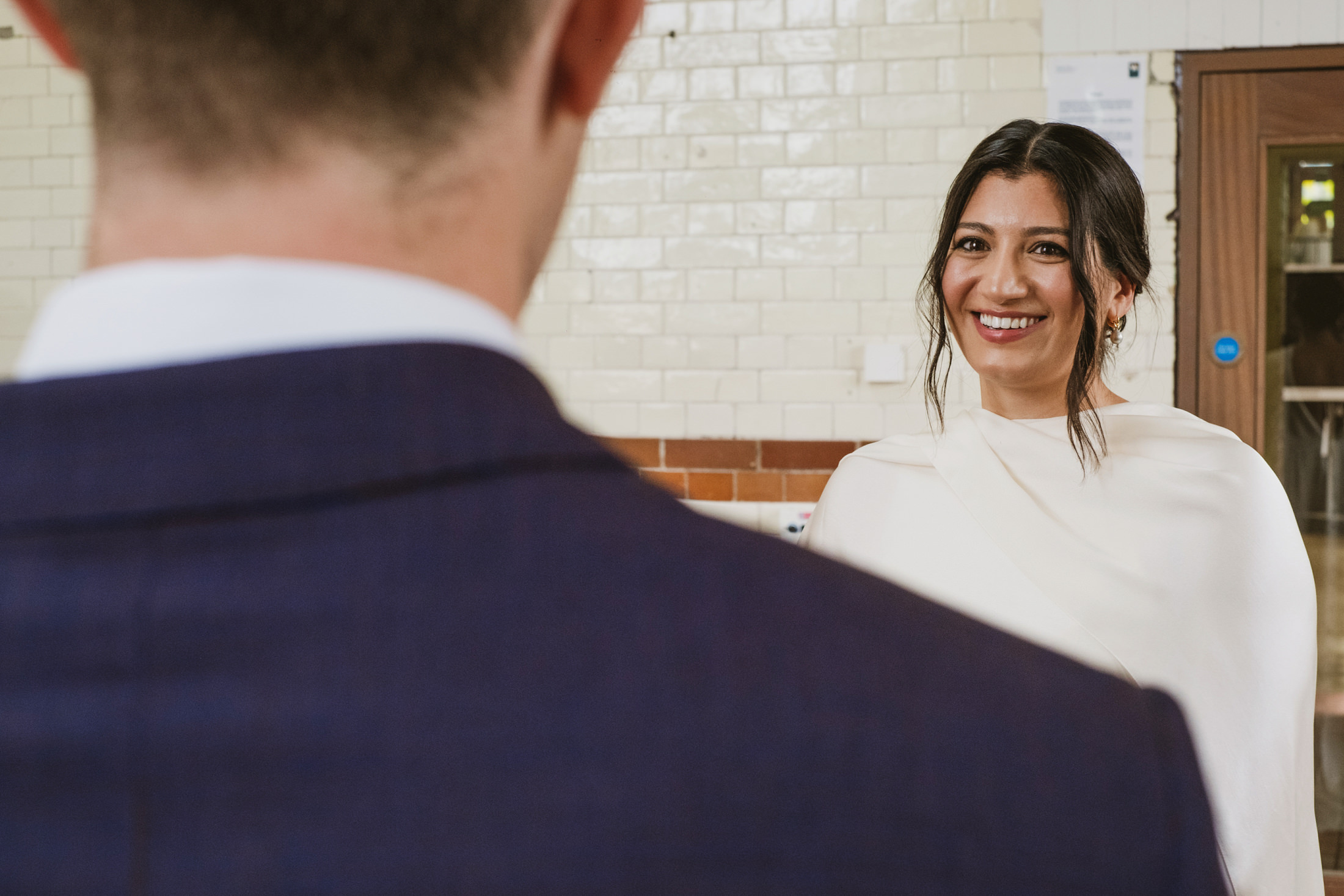 Woman smiling at man in a suit.