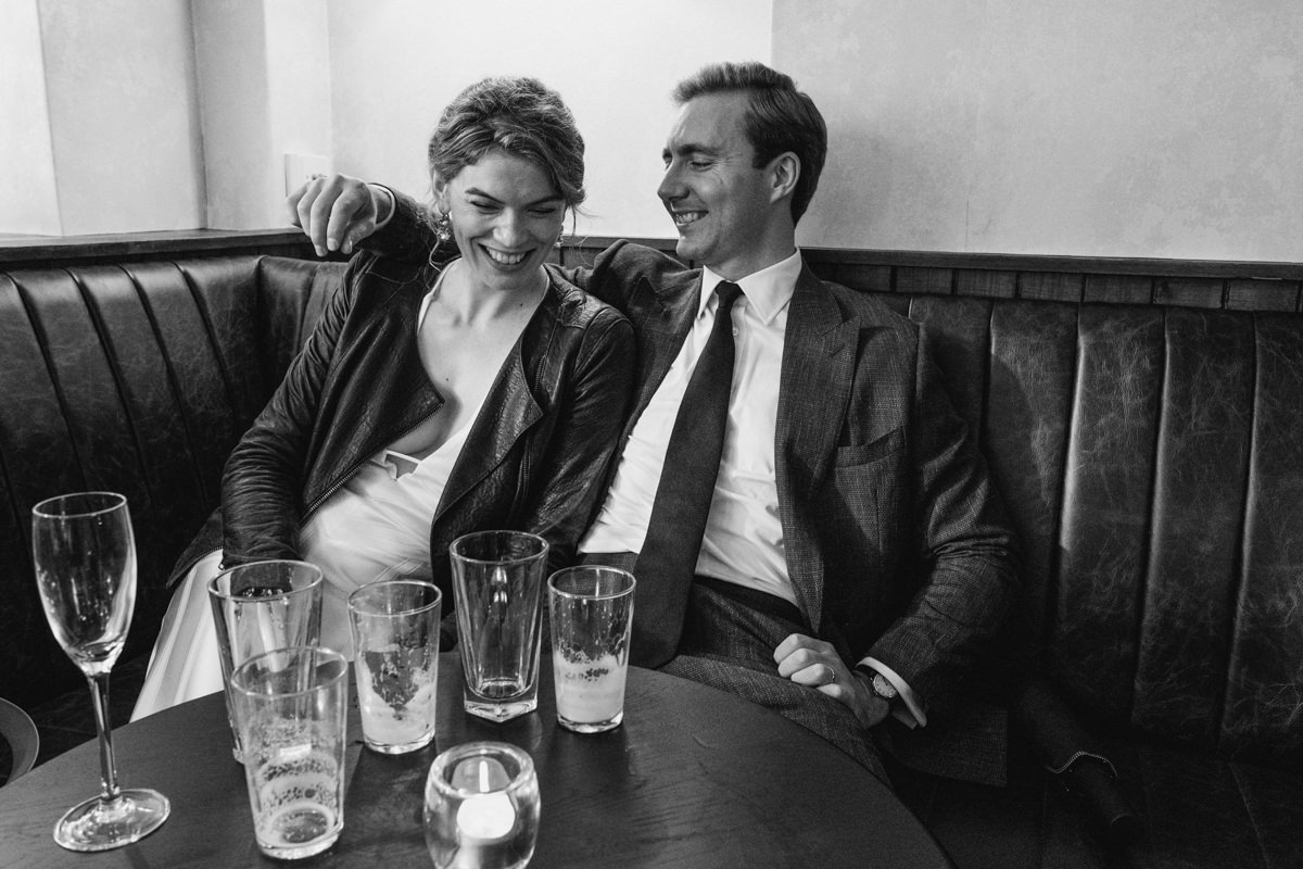 Smiling couple sitting in a cosy restaurant booth.