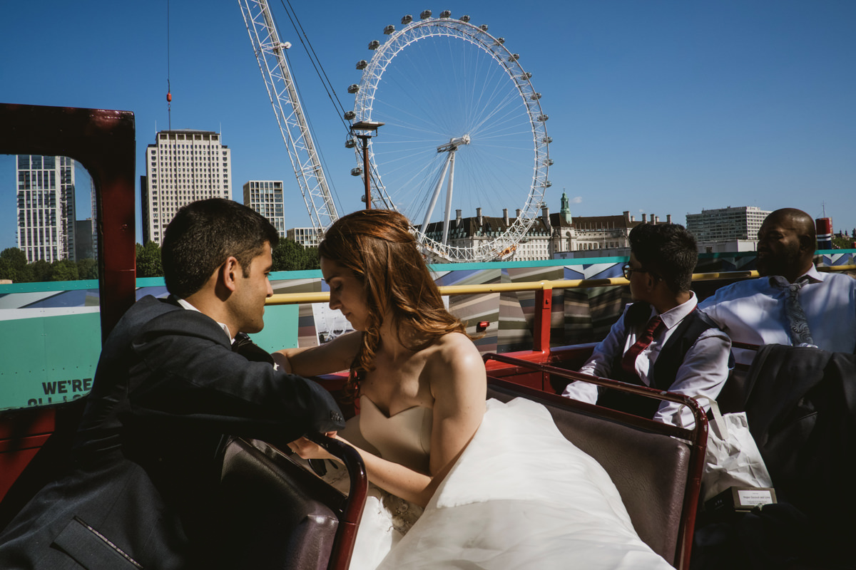 Couple on bus, London Eye in background.