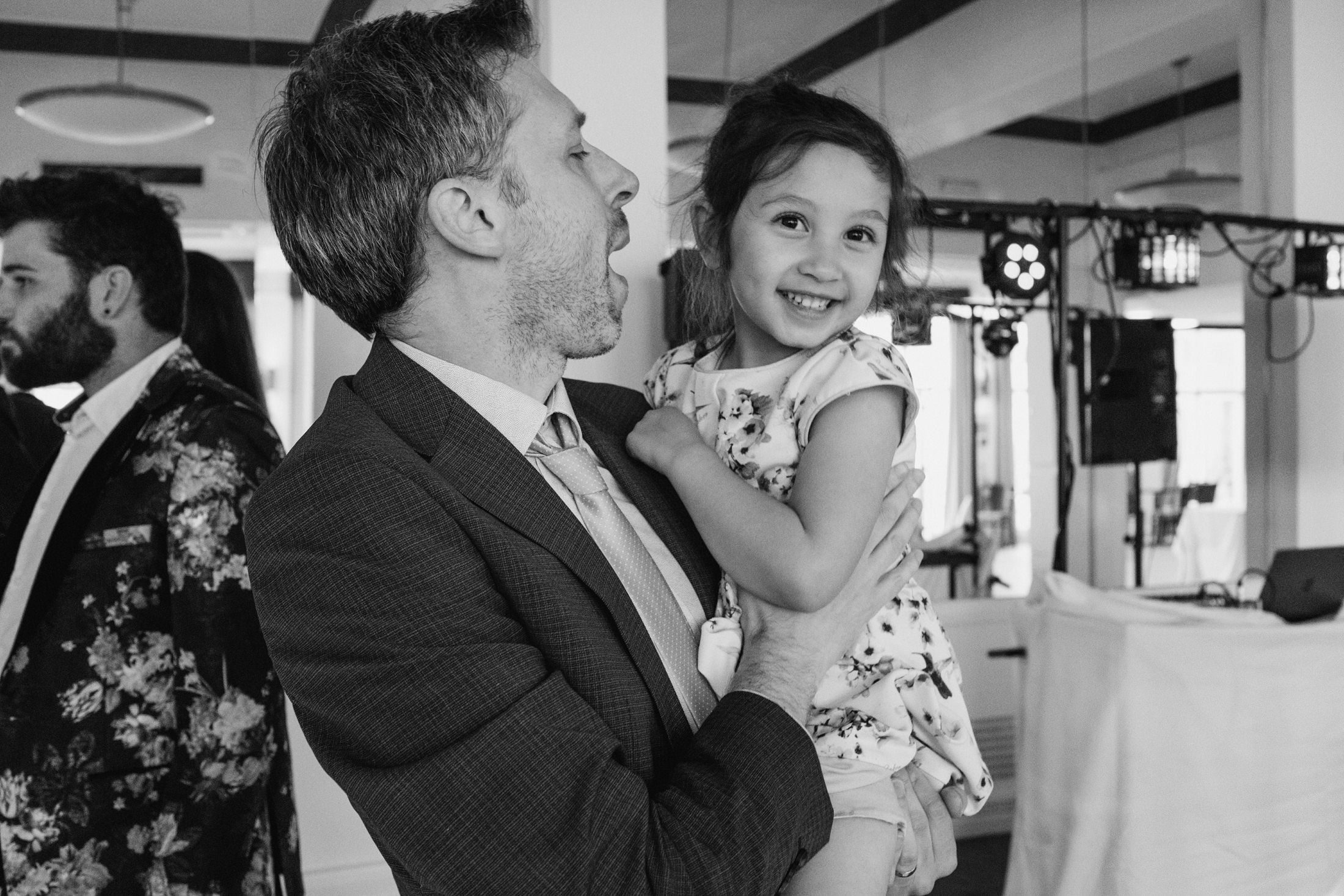 Man holding smiling child at an event