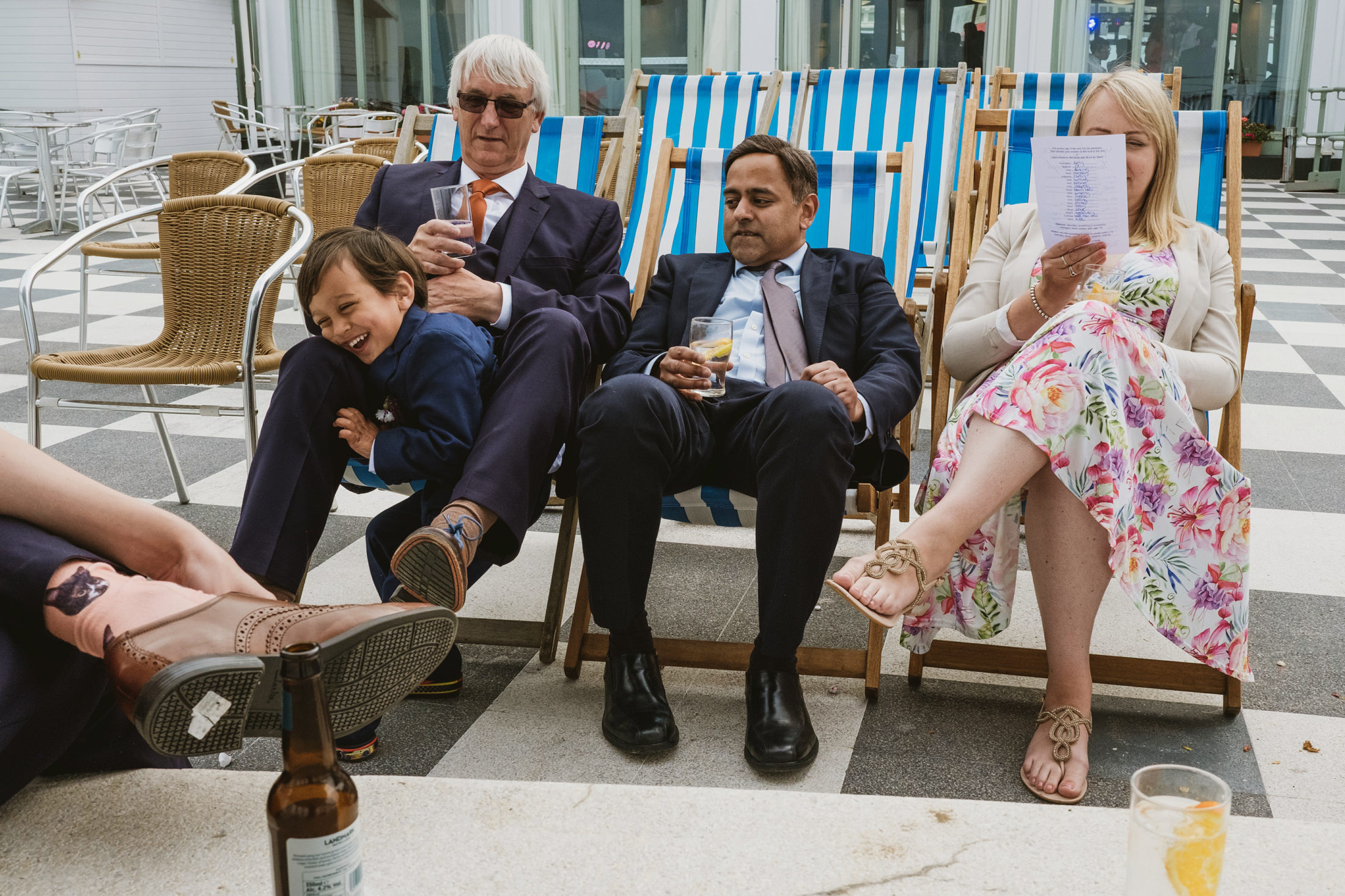 People relaxing on deck chairs outdoors.